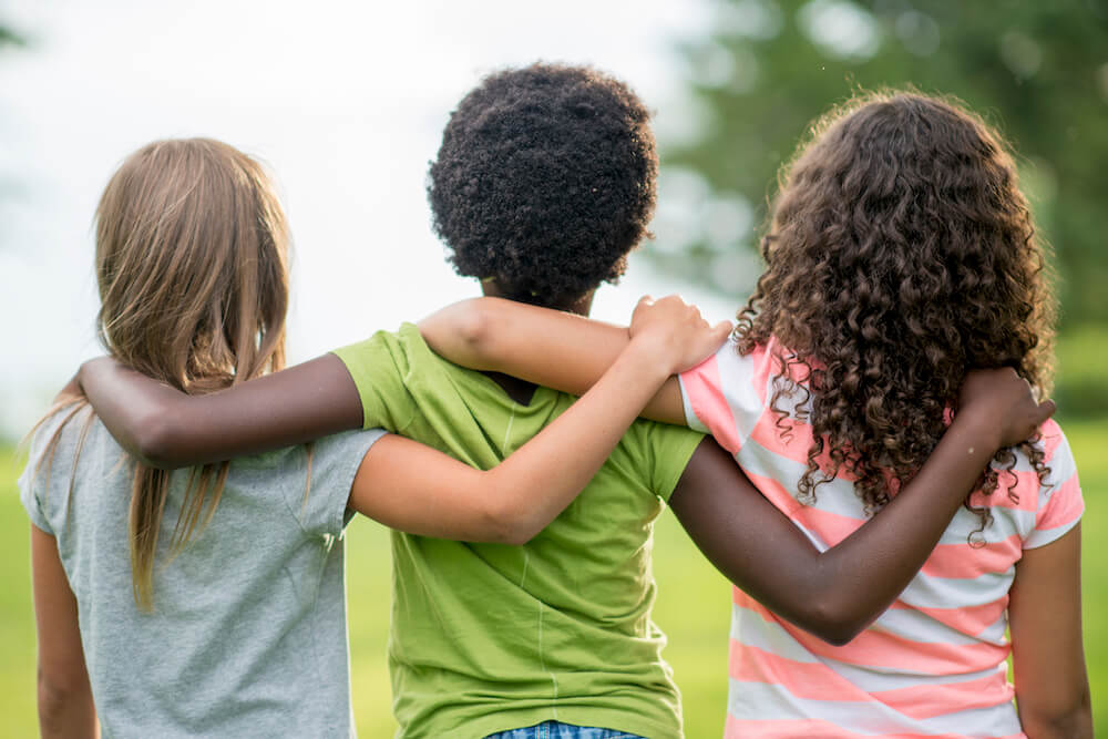 Girls with their arms around each other
